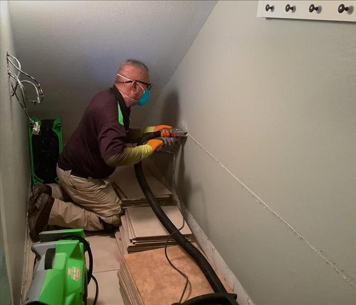 technician preparing to cut wall for faster drying process
